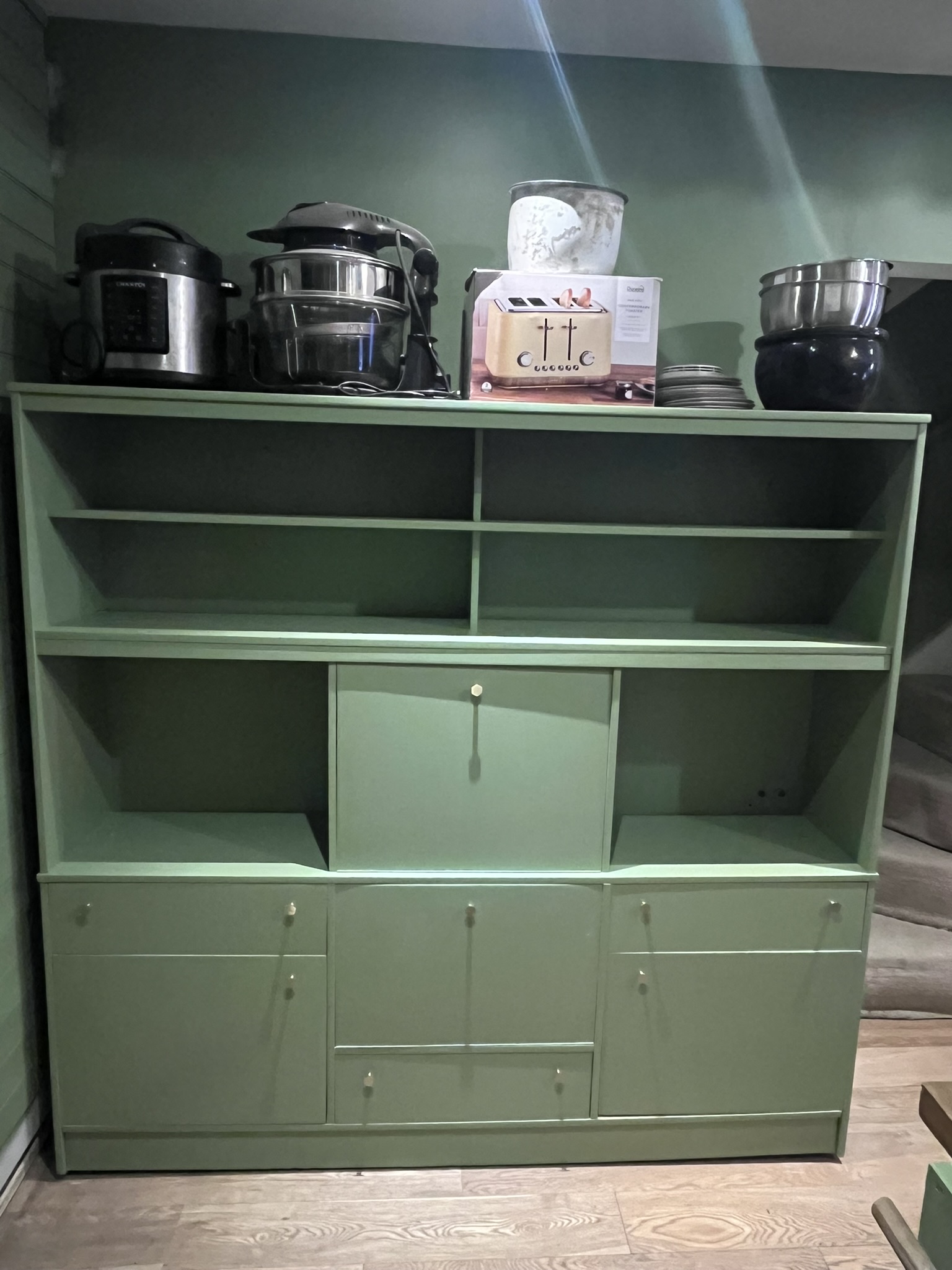 Green painted wall unit after restoration